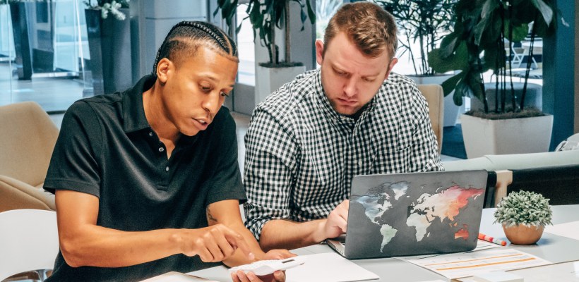 hiring manager sitting and talking to a new hire on their first day at the new job